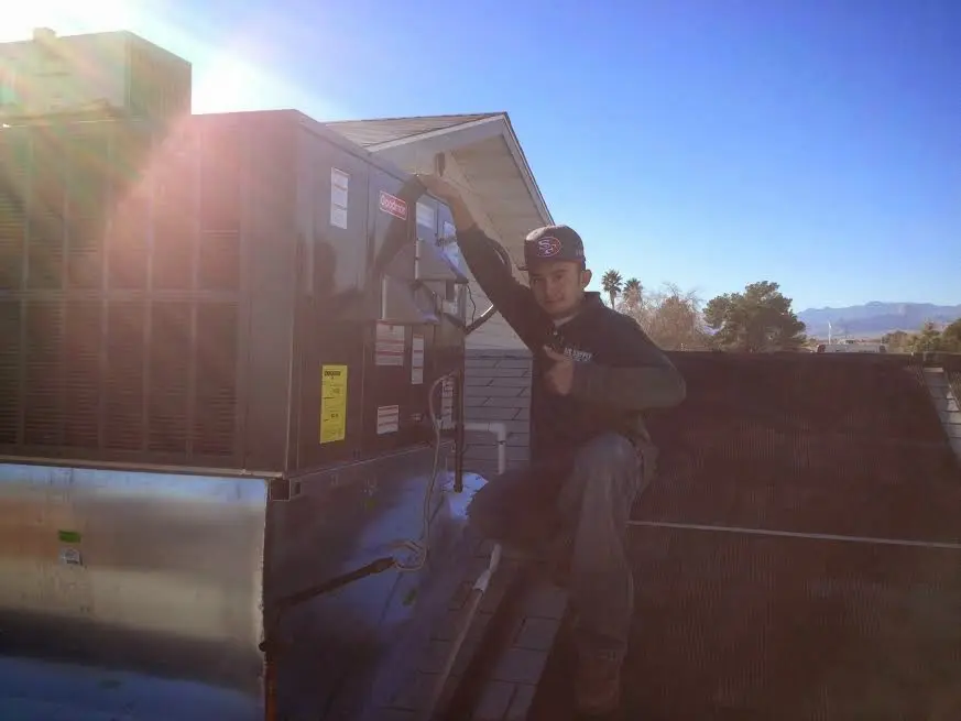 HVAC technician performing HVAC Inspection on a rooftop unit in Chippewa Falls